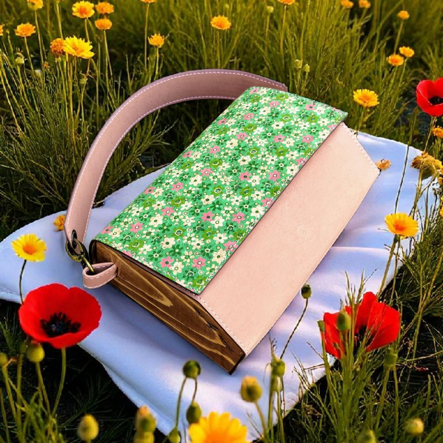 Floral-patterned handbag on a white surface with flowers in the background